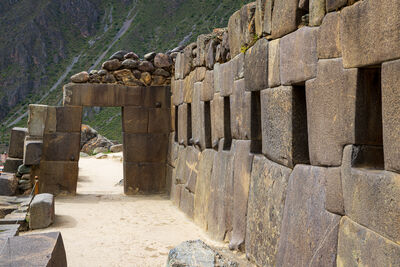 Hallway with niches leading to a trapezoid doorway