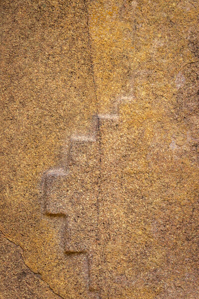 Carving on a rock wall